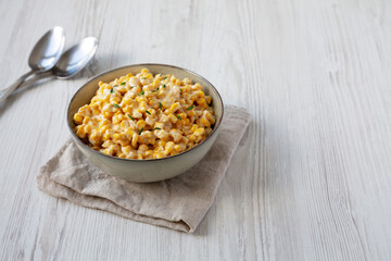 Homemade Slow Cooker Creamed Corn in a Bowl, side view. Space for text.
