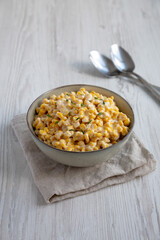 Fototapeta na wymiar Homemade Slow Cooker Creamed Corn in a Bowl, side view.