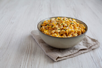 Homemade Slow Cooker Creamed Corn in a Bowl, low angle view. Space for text.