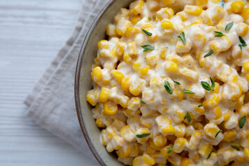Homemade Slow Cooker Creamed Corn in a Bowl, top view. Flat lay, overhead, from above. Copy space.