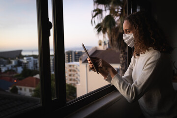 Woman using her digital tablet. Social distancing in quarantine lockdown during coronavirus epidemic