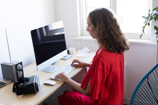 Caucasian woman using her computer at home during coronavirus Covid19 pandemic