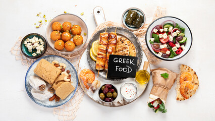 Greek cuisine dishes on neutral background.