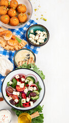 Greek cuisine dishes on neutral background.