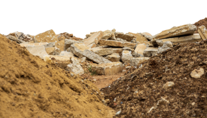 A pile of rubble isolates of concrete blocks obtained from the demolition of an old road was laid near a mound of earth and sand as a foreground.