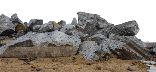 Isolated close-up view of a large pile of concrete rubble from a road demolition for renovation on a pile of sand against a white background.