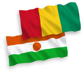 National vector fabric wave flags of Republic of the Niger and Guinea isolated on white background. 1 to 2 proportion.