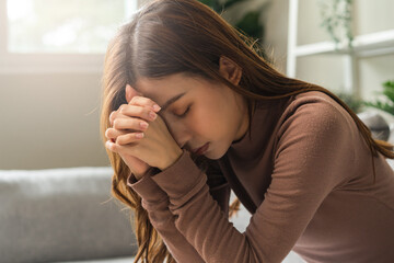 Believe faith charity, calm asian young woman show gratitude, folded hands in prayer feel grateful, meditating with her eyes closed, praying to request God for help. Religious, forgiveness concept. - obrazy, fototapety, plakaty