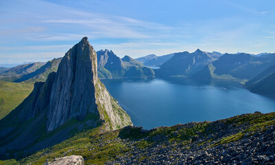 View from the mount Hesten on iconic mountain Segla in a summer sunny day. Mountain ranges at the...