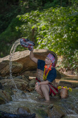 Beautiful Asian young tribal lady in the native traditional dress culture of Karen people minority ethnic culture. Portraits of identity dress folk applying fashion concepts.