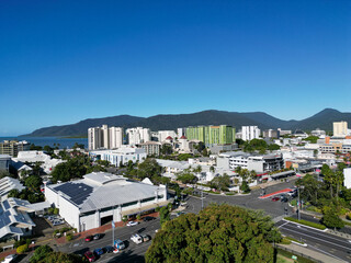 Aerial photo of park and city scape with mountains and blue sky in the background