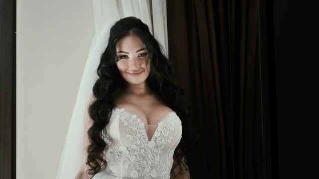 beautiful and attractive bride with big bust smiling looking at the camera