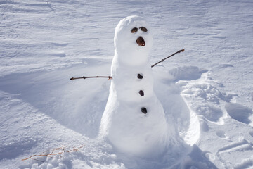 Snowman in the snow during winter