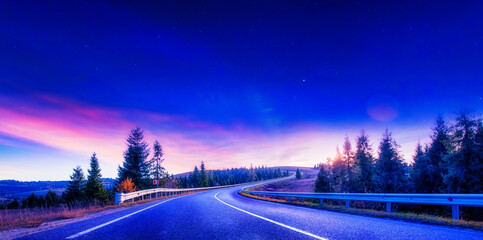 Fototapeta na wymiar High-quality asphalt road in the mountains before dawn.