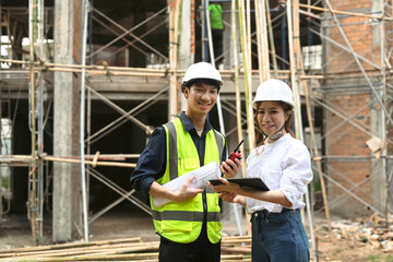 Female architects and engineer standing with arms crossed at construction site. Industry, Engineer, construction concept