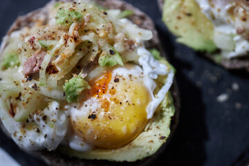 homemade delicious toast, topped with egg, tuna, cucumber and avocado