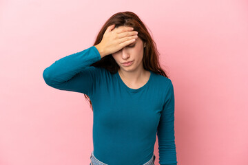 Young caucasian woman isolated on pink background with headache