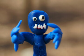 A figure of a funny blue zombie in close-up. Portrait of a toy monster.