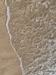 Soft sea wave on the beach, sand background
