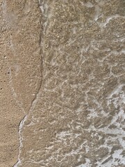 Soft sea wave on the beach, sand background

