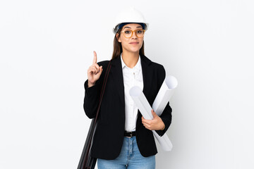 Young architect caucasian woman with helmet and holding blueprints over isolated background...