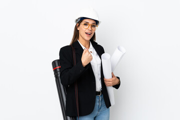 Young architect caucasian woman with helmet and holding blueprints over isolated background celebrating a victory