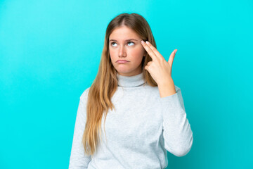 Fototapeta premium Young blonde woman isolated on blue background with problems making suicide gesture