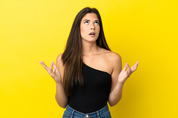 Young Brazilian woman isolated on yellow background stressed overwhelmed