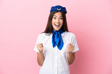 Airplane stewardess Brazilian woman isolated on pink background celebrating a victory in winner position
