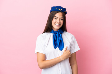 Airplane stewardess Brazilian woman isolated on pink background giving a thumbs up gesture