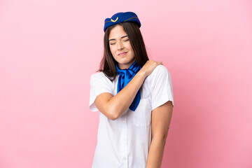 Airplane stewardess Brazilian woman isolated on pink background suffering from pain in shoulder for having made an effort