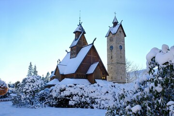 Fototapeta na wymiar Old wooden stave church Vang (Wang) in winter. It was transferred from Norway and re-erected in 1842 in Karpacz, Poland