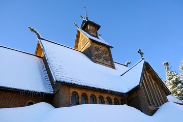 Old wooden stave church Vang (Wang) in winter. It was transferred from Norway and re-erected in...