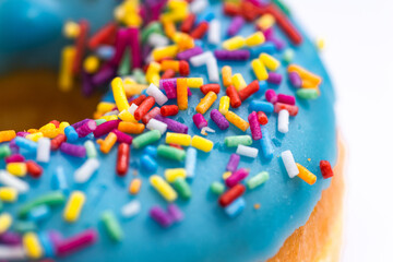 Fototapeta na wymiar Macro shot of colorful sprinkles on a donut. Background banner. Free space.