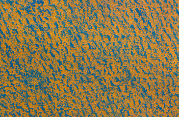 The pattern on the plasterboard is painted with blue and yellow acrylic paint.