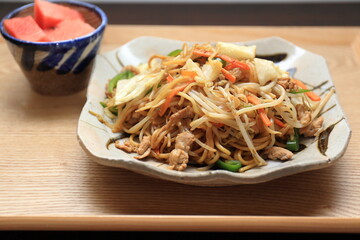 A large plate of sauce flavored fried noodles served further