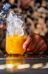 bartender making cocktail with fruit in a nightclub bar