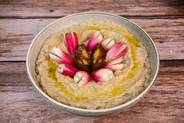 Eggplant caviar with homemade and radish and tomatoes on wooden background. High quality photo