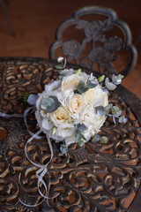Delicate fragile wedding bouquet with cream roses