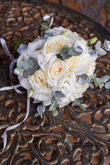 Delicate fragile wedding bouquet with cream roses