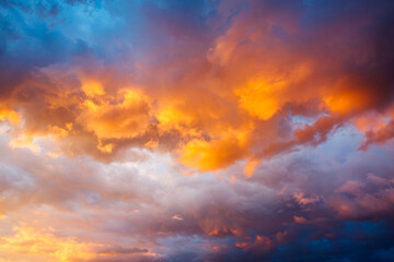 An epic sunset with colorful clouds lit by the sun. Photo of textured sky.