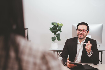 Businessman, Confident Male executive commuter is looking at hand held digital tablet screen. Confident professional making successful plan while working on laptop at office.