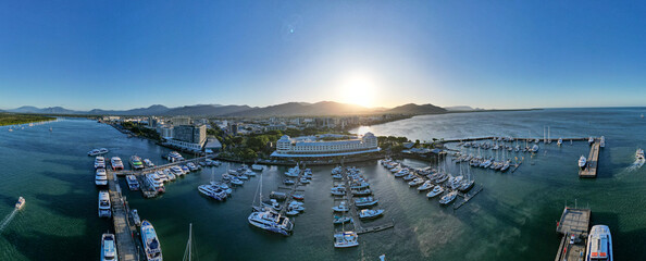 Aerial panorama of Cairns city and boat harbour at sunset