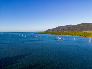 Aerial photo of perfect blue water and sky with mountains and boats