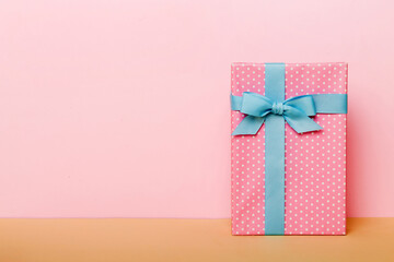 holiday handmade paper present tied blue ribbon bow top view with copy space. Flat lay holiday background. Birthday or christmas present. Christmas gift box concept with copy space