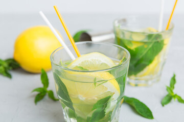 Mojito summer refreshing cocktail with ice and mint. mojito cocktail with lime, lemon and mint in a tall glass with a stick