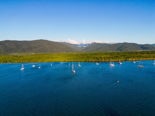 Aerial photo of perfect blue water and sky with mountains and boats