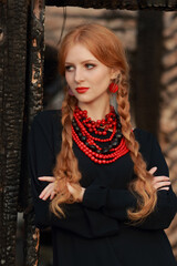 Beautiful Woman in traditional ukrainian style. Ukrainian National Costume. Gorgeous young Woman with red lips. Portrait attractive Girl with a red necklace. Slavonic Girl with long blond hair.