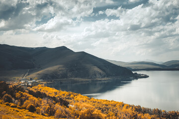 Dramatic mountain lake autumn scene. Incredible fall scenery. Scenic mountain landscape. Awesome alpine highlands in moody day. Stunning natural background. Travel to Armenia. Retro vintage toning