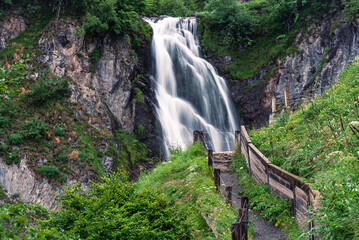 Beautiful waterfall in the mountains (Saut deth Pish, Pyrenees Mountains, Vall d'Aran, Spain)